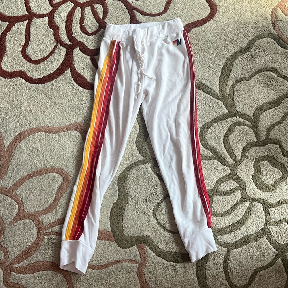 aviator nation white sweatpants with red, orange, and yellow stripes